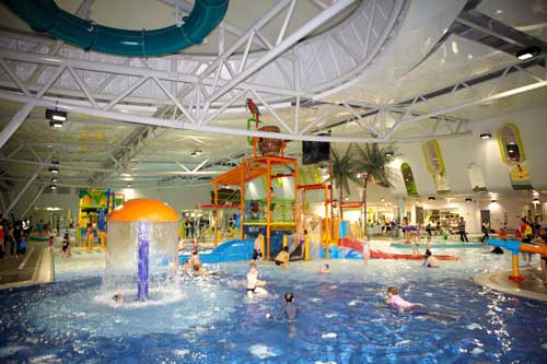 Photo of a swimming pool with a large playground in the middle of the pool