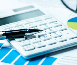 calculator, pen and report on a desk