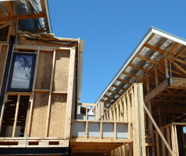 Domestic home in the building stage with wooden frame and bare roof.