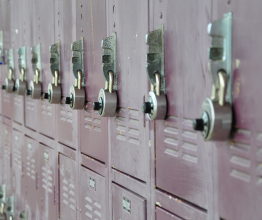 A wall of outside lockers with combination locks.