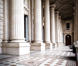 External columns and a tiled floor leading to an entrance of Parliament House in Victoria.